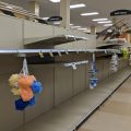 Empty grocery store shelves with loofahs hanging in front